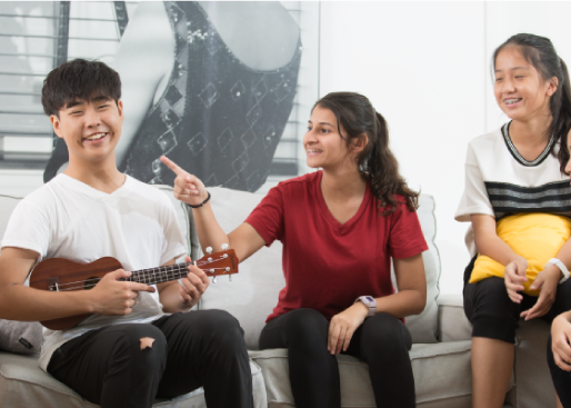group of students playing guitar and having fun